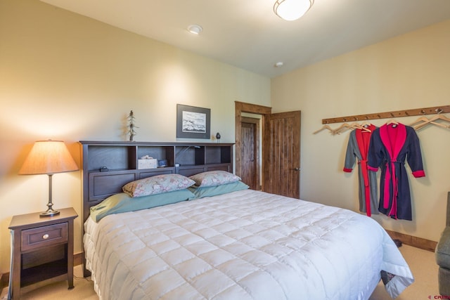 bedroom with carpet floors and baseboards