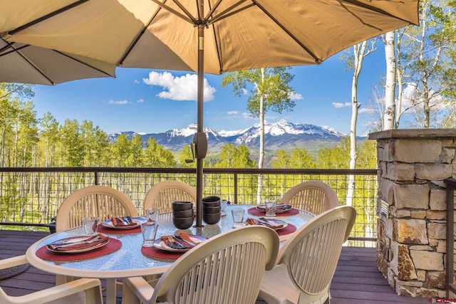 deck featuring a mountain view and outdoor dining area