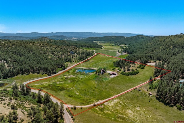 aerial view featuring a mountain view and a wooded view