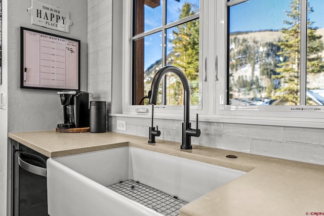 room details with light countertops, a sink, and decorative backsplash