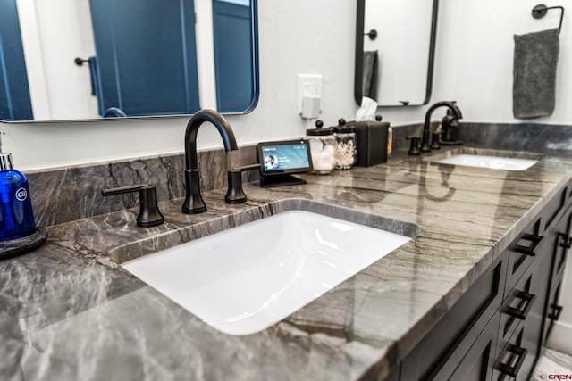 full bath featuring double vanity and a sink