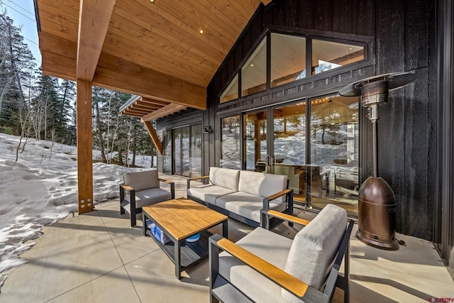 snow covered patio featuring outdoor lounge area