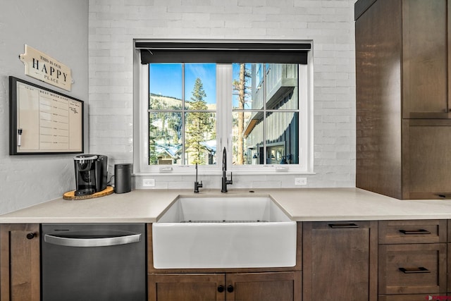 kitchen with decorative backsplash, light countertops, a sink, and dishwasher