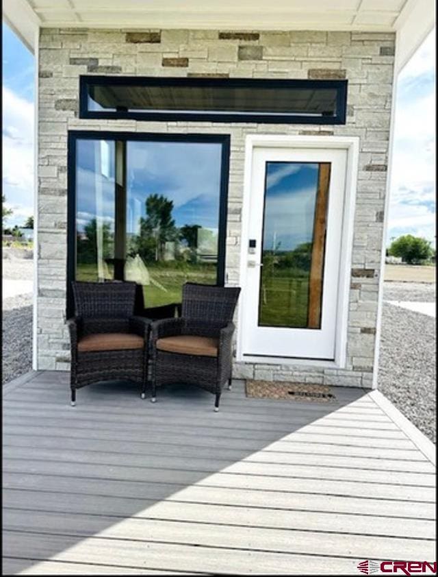 doorway to property with stone siding