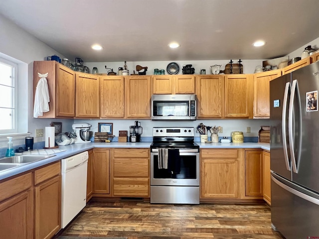 kitchen featuring appliances with stainless steel finishes, recessed lighting, light countertops, and dark wood-style floors