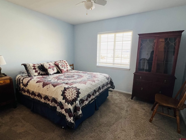 bedroom with dark colored carpet and a ceiling fan