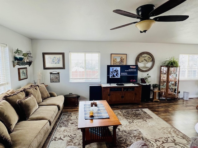 living area with dark wood-style floors and a ceiling fan