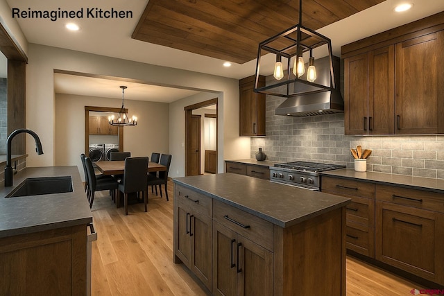 206 Pines Club Pl, Pagosa Springs, CO 81147 - kitchen featuring a sink, a chandelier, washing machine and clothes dryer, dark countertops, and wood ceiling