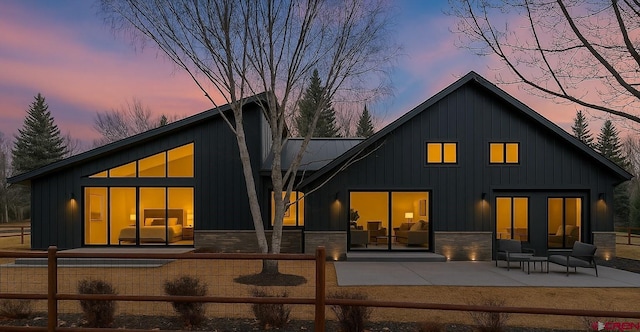 206 Pines Club Pl, Pagosa Springs, CO 81147 - back of property featuring board and batten siding and a patio