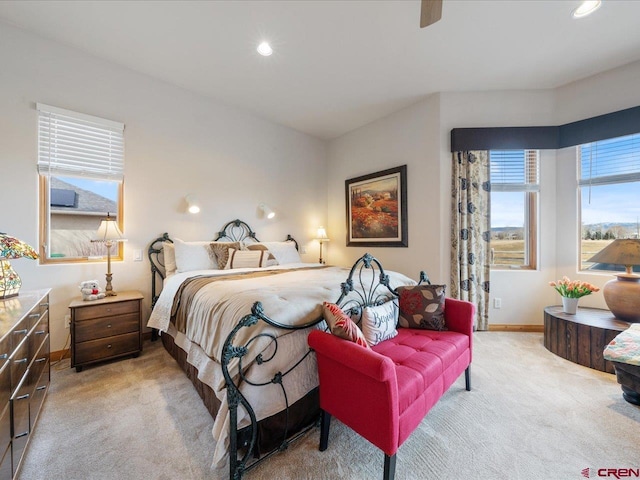 bedroom featuring a ceiling fan, recessed lighting, light colored carpet, and baseboards