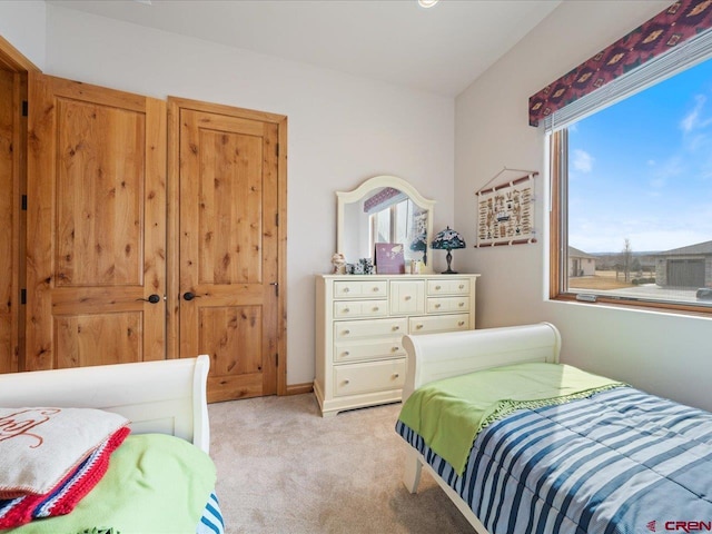 bedroom featuring light colored carpet