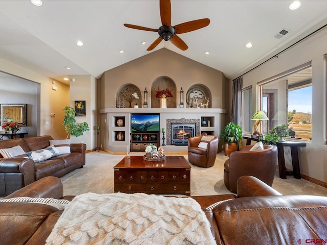 living room with light carpet, baseboards, visible vents, a glass covered fireplace, and lofted ceiling