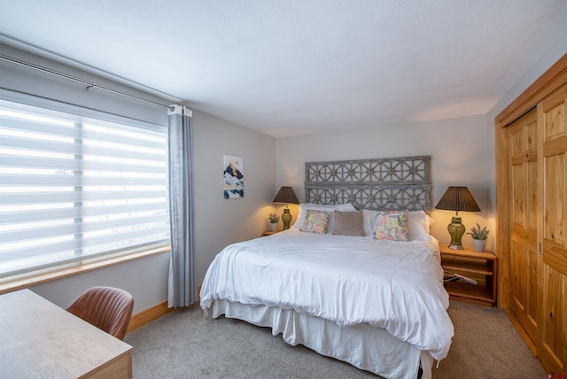 bedroom with baseboards and carpet flooring