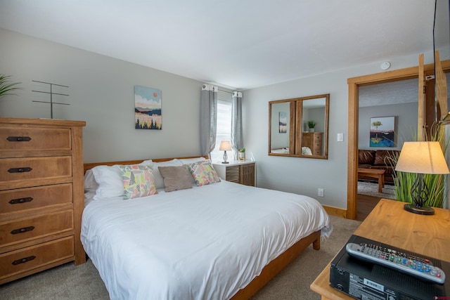 carpeted bedroom featuring baseboards