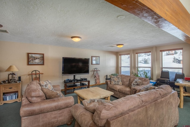 carpeted living area featuring visible vents and a textured ceiling