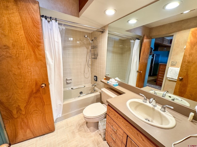 bathroom featuring vanity, shower / bath combo with shower curtain, toilet, and recessed lighting