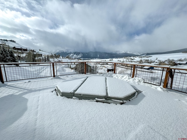 yard covered in snow with fence and a mountain view