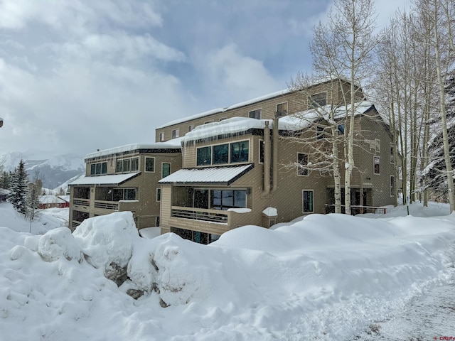 snow covered house with a garage