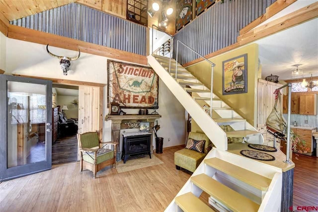 stairway with a high ceiling and wood finished floors