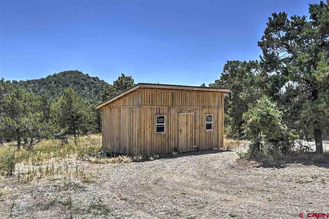 view of outdoor structure featuring a mountain view and an outbuilding