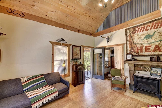 living area featuring light wood finished floors, wood ceiling, and high vaulted ceiling