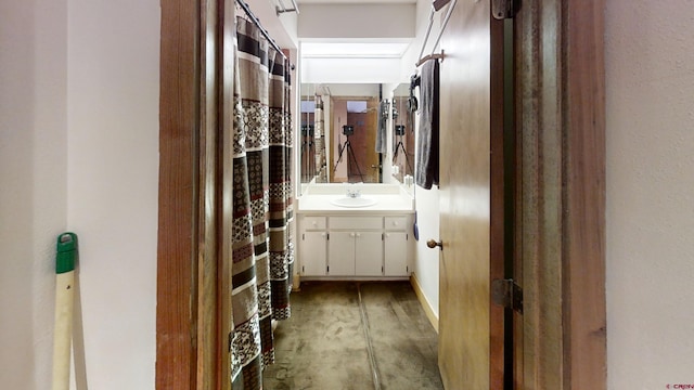 full bath with concrete flooring and vanity