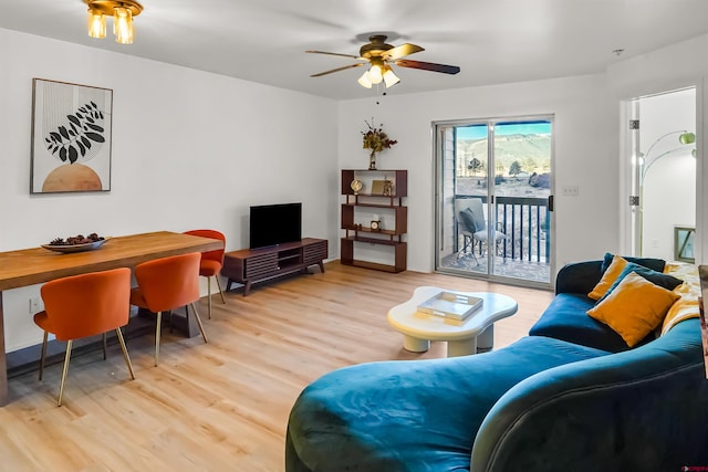 living area with light wood finished floors and a ceiling fan