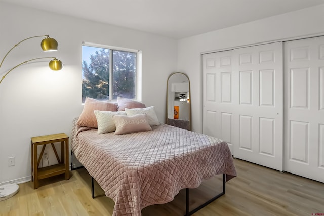 bedroom featuring a closet and light wood-style flooring