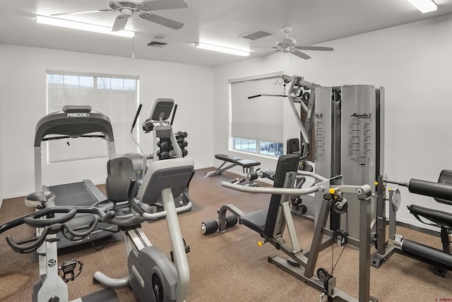 workout area featuring a ceiling fan, visible vents, and baseboards