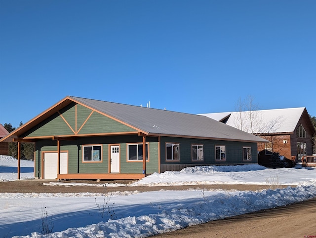 view of front of property with an attached garage and metal roof