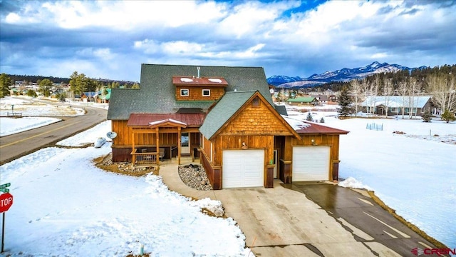 rustic home featuring a garage and a mountain view