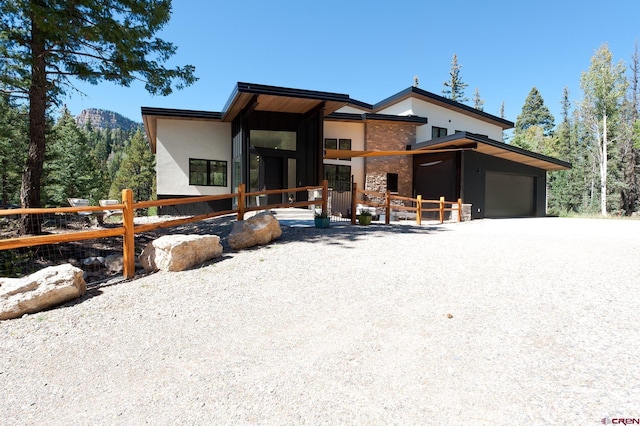 contemporary home with an attached garage and stucco siding