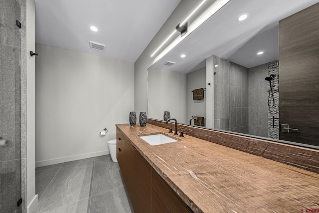 full bathroom featuring toilet, a walk in shower, visible vents, and baseboards