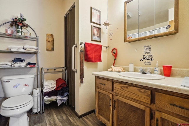 full bath with vanity, toilet, and wood finished floors