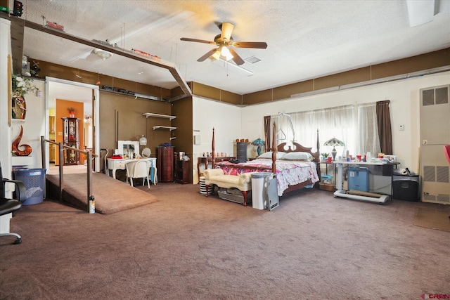 carpeted bedroom with a textured ceiling, visible vents, and a ceiling fan