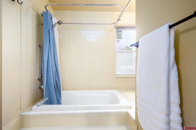 full bathroom with a healthy amount of sunlight and shower / bathtub combination with curtain