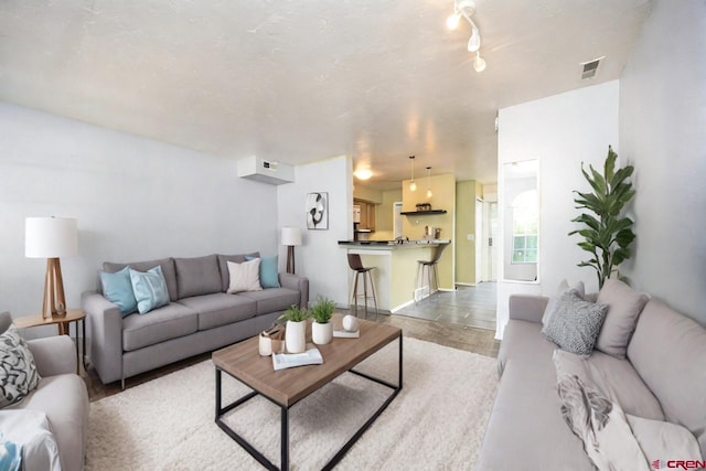 living room featuring baseboards and visible vents