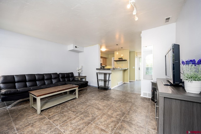 living room with visible vents and baseboards