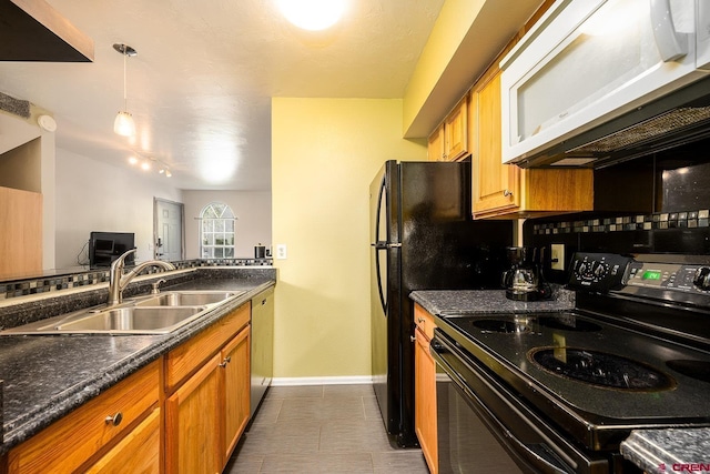 kitchen with white microwave, black range with electric cooktop, dark countertops, and a sink