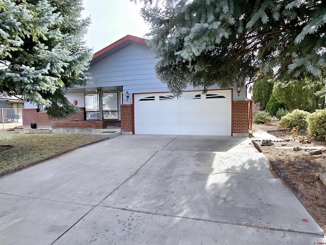 ranch-style house with driveway, an attached garage, and brick siding