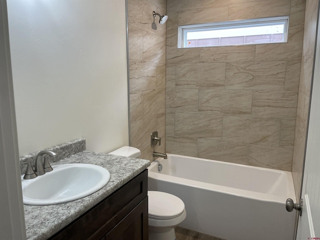 bathroom featuring bathing tub / shower combination, toilet, and vanity