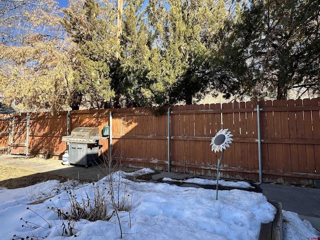 yard covered in snow with fence