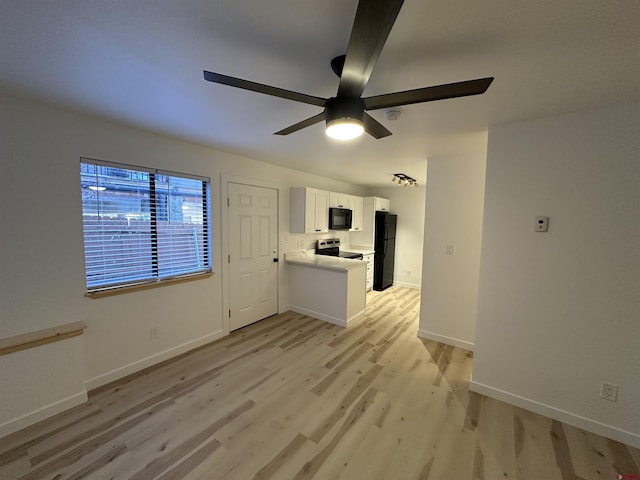 unfurnished living room with ceiling fan, light wood-style flooring, and baseboards