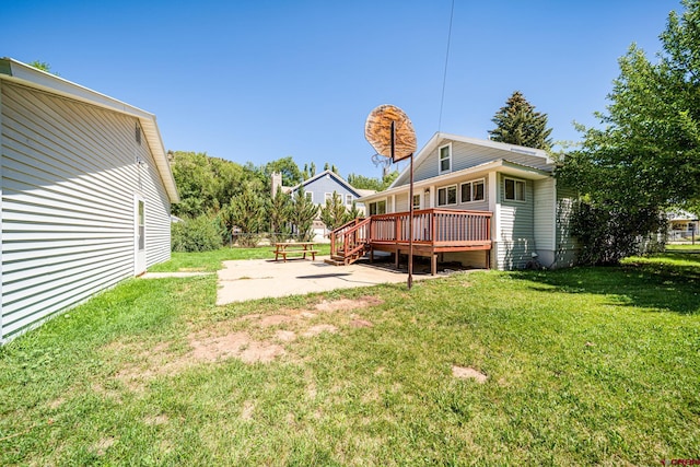 view of yard featuring a patio area and a deck