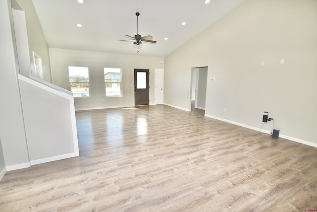 unfurnished living room featuring baseboards, a ceiling fan, light wood-style flooring, high vaulted ceiling, and recessed lighting