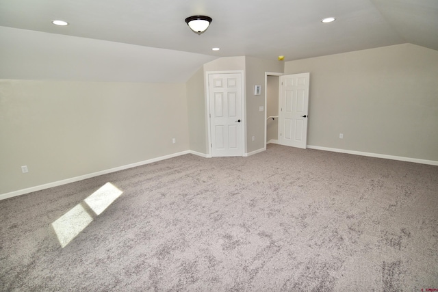 bonus room with lofted ceiling, recessed lighting, carpet flooring, and baseboards