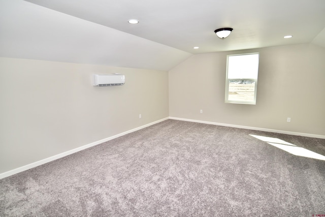 additional living space featuring recessed lighting, baseboards, vaulted ceiling, a wall mounted AC, and carpet