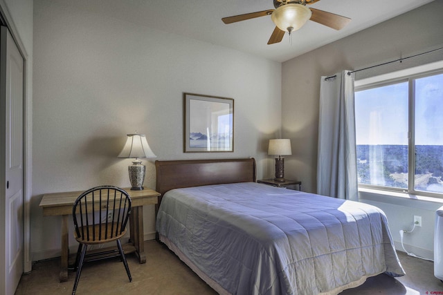 bedroom featuring ceiling fan, multiple windows, and baseboards