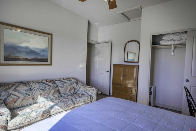 bedroom with ceiling fan, a closet, and attic access