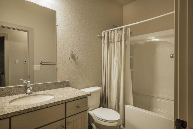 full bathroom with shower / bath combination with curtain, a textured wall, vanity, and toilet